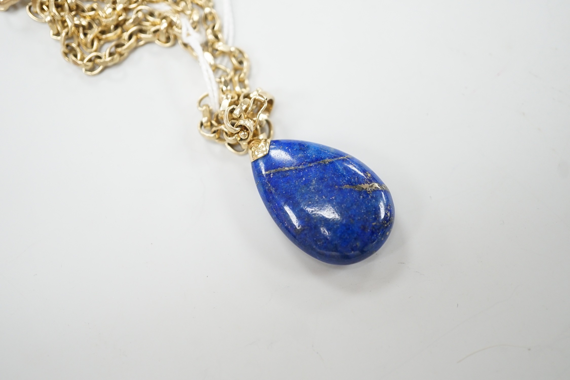 A modern 9k mounted lapis lazuli pendant, 35mm, on a 375 chain, 48cm, chain, 18.5 grams.